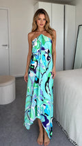 Model wearing turquoise abstract print halter maxi dress front view