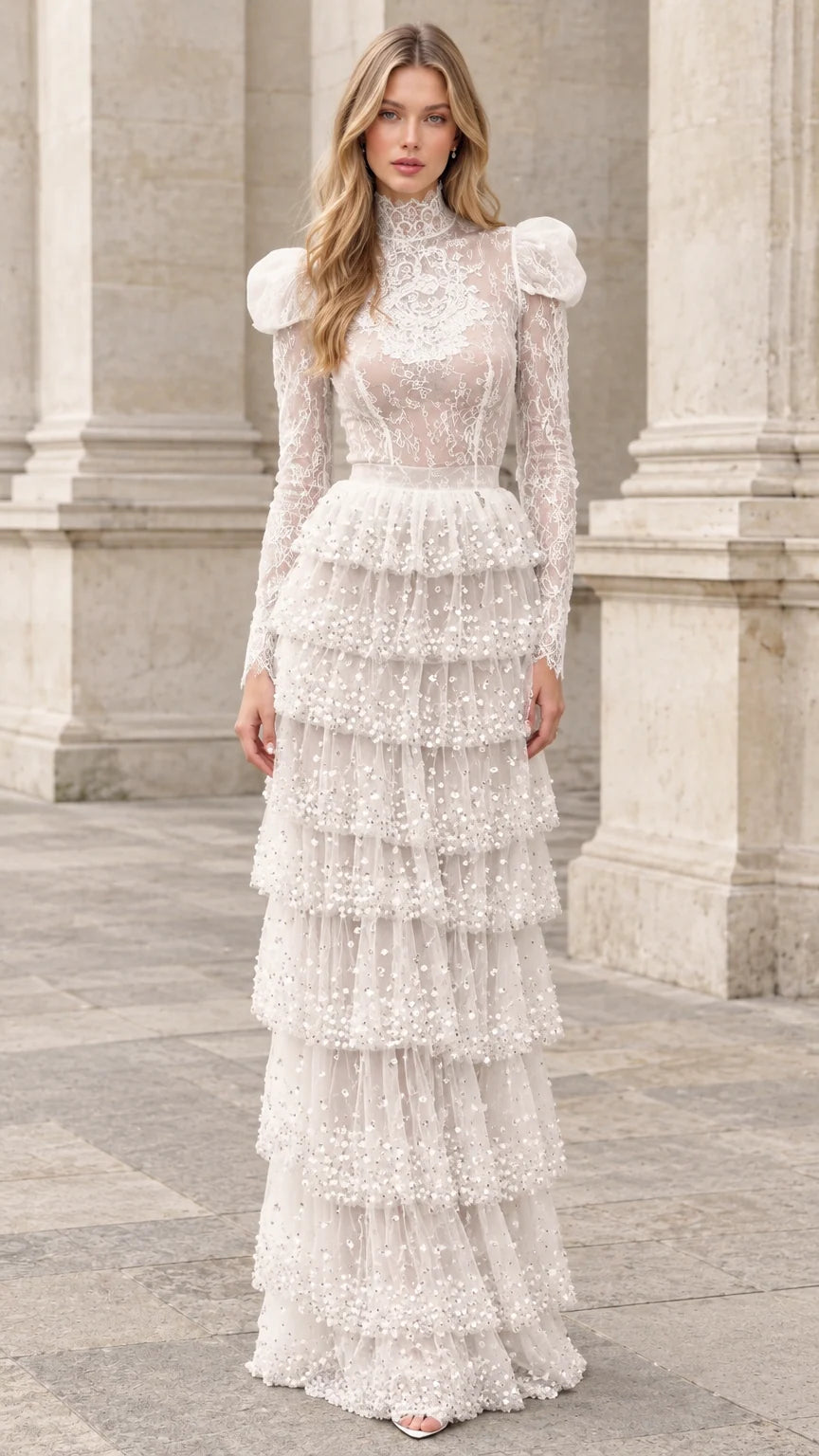 Front full-length view of model wearing ivory high-neck tiered lace maxi dress with puff shoulders