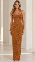 Front view of model wearing rust orange beaded halter neck column evening gown