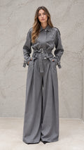 Full front view of model wearing grey embellished belted wide-leg jumpsuit