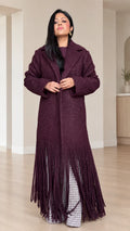 Full front view of model wearing Deep Burgundy textured bouclé maxi coat with fringe hem
