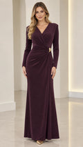 Front full-length view of model wearing plum long sleeve shimmer maxi evening dress with ruched waist detail