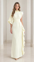 Full front view of butter yellow asymmetrical one-sleeve maxi dress with floral collar and side ruffle
