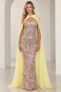 Front view of model wearing yellow floral embroidered strapless evening gown with matching sheer cape
