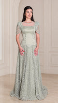 Front view of model wearing Sage Green beaded short sleeve evening gown