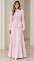 Front view of model wearing blush pink tweed peplum jacket and matching maxi skirt suit set