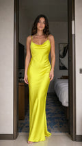 Model wearing bright yellow satin cowl neck maxi dress from the front