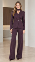 Front view of woman wearing burgundy pinstripe choker neckline blazer and wide leg trousers set