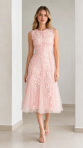 Front view of model wearing pink embroidered leaf applique midi dress