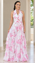Front view of woman wearing white floral halter neck tiered maxi dress