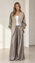 Front view of model wearing taupe textured blazer with satin balloon sleeves and matching wide-leg trousers