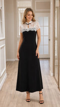 Front view of model wearing black lace yoke A-line maxi dress with keyhole collar