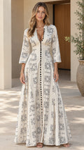 Front full view of woman wearing off-white geometric print V-neck maxi dress with 3/4 sleeves