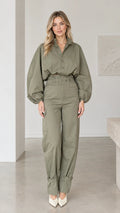 Front full-length view of woman wearing olive green lantern sleeve cargo jumpsuit