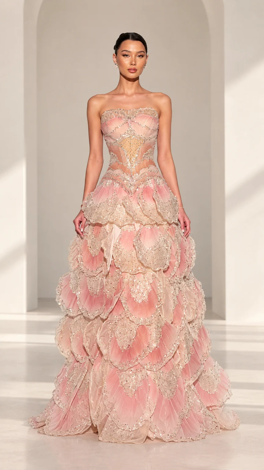 Front full view of Blush Pink strapless beaded corset evening gown with petal tiered skirt
