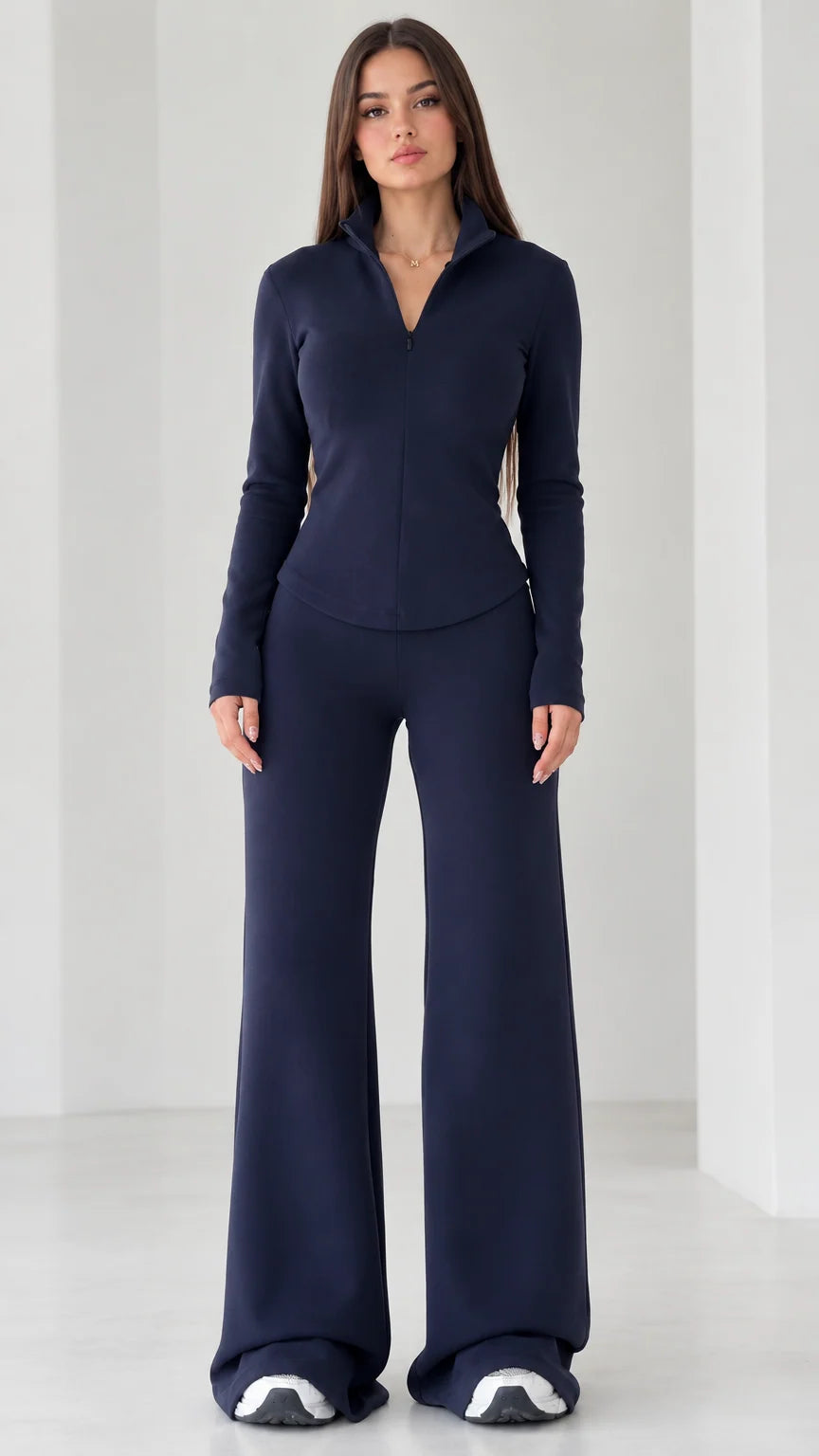 Full front view of women's navy blue quarter-zip top and wide-leg flare pants set