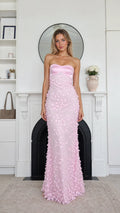 Front view of model wearing pink strapless floral applique maxi dress