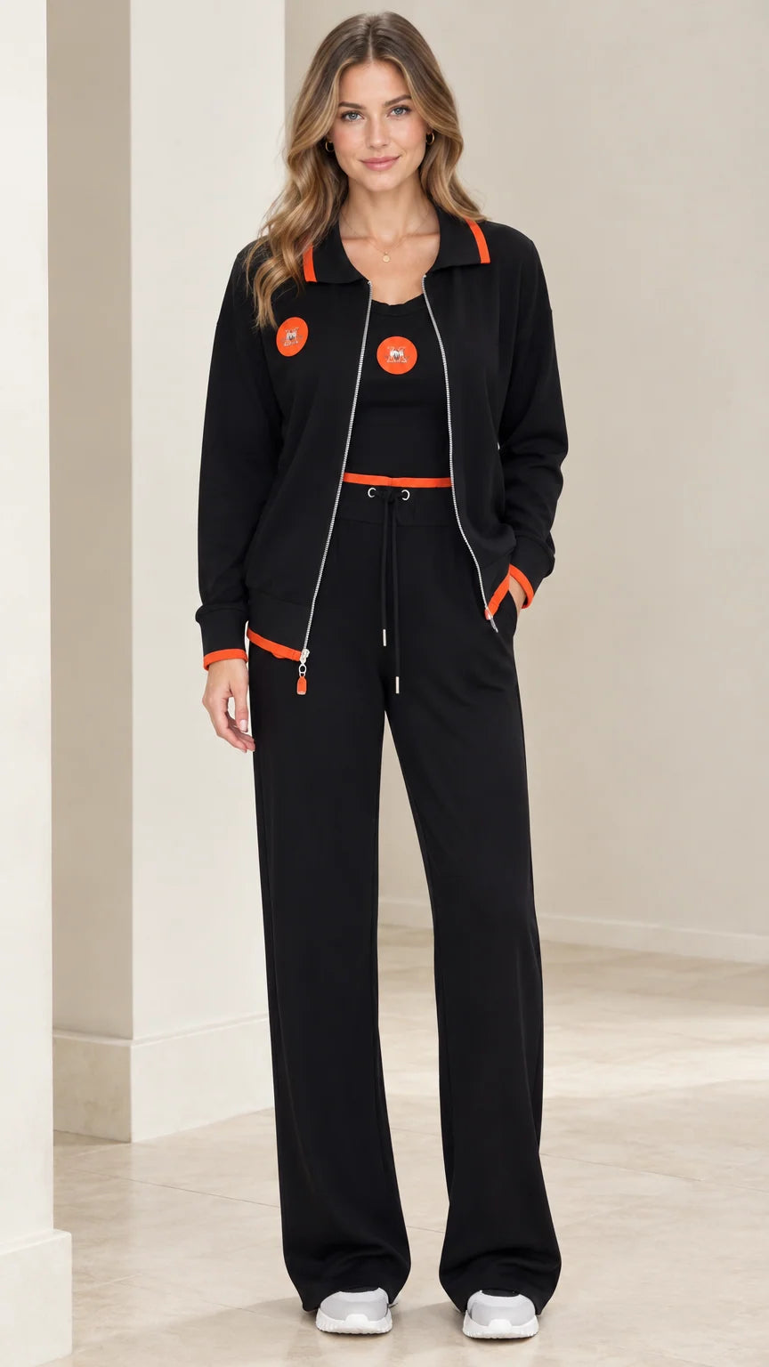 Front view of model wearing black 3-piece tracksuit set with orange trim