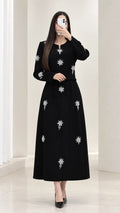 Front view of black rhinestone embellished long sleeve top and maxi skirt set