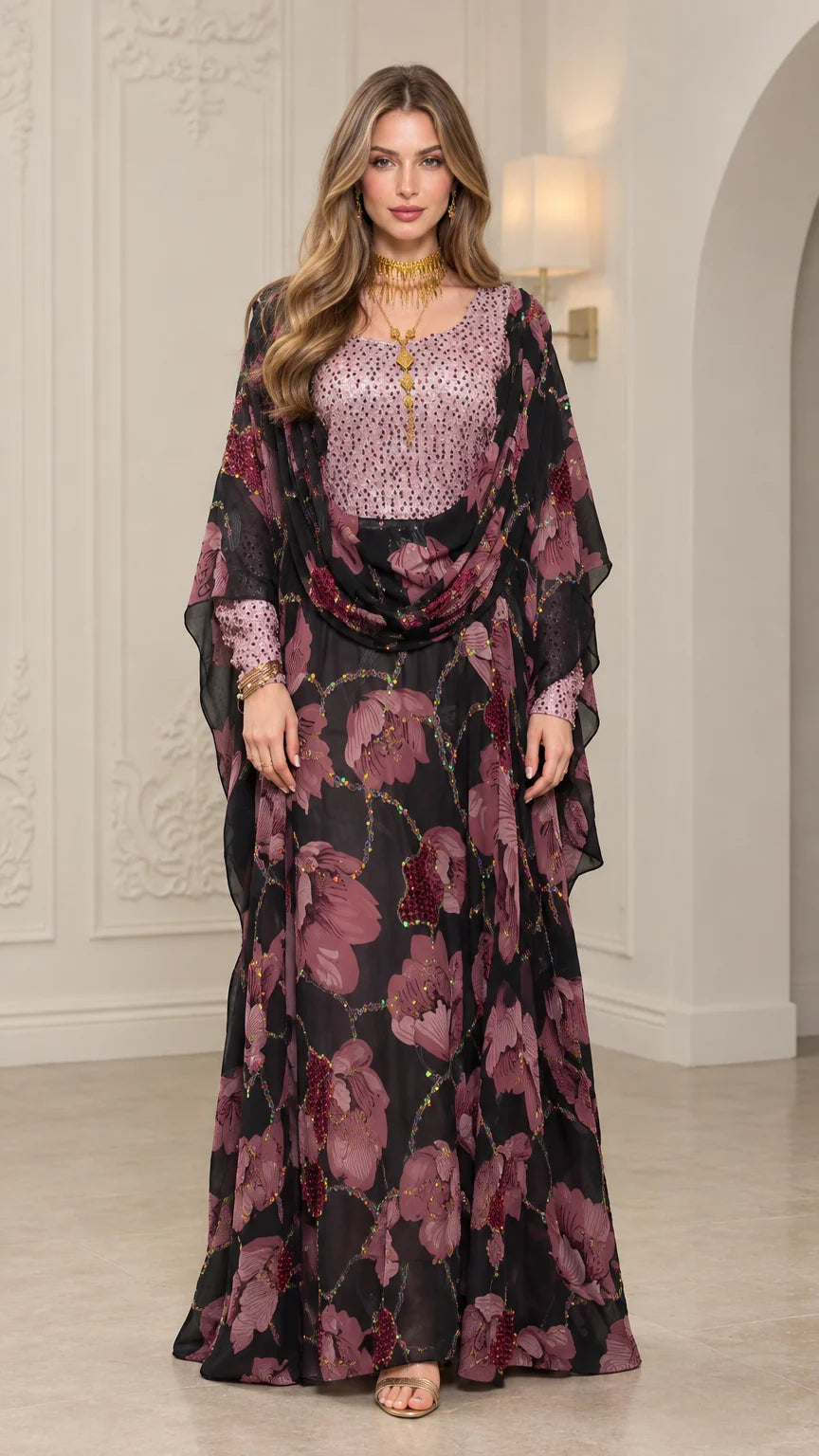 Front view of woman wearing Black floral embellished kaftan maxi dress with draped cape overlay