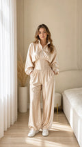 Model wearing champagne satin corset waist tracksuit set front view