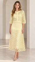 Pale yellow openwork crochet cardigan and midi skirt two-piece set on model