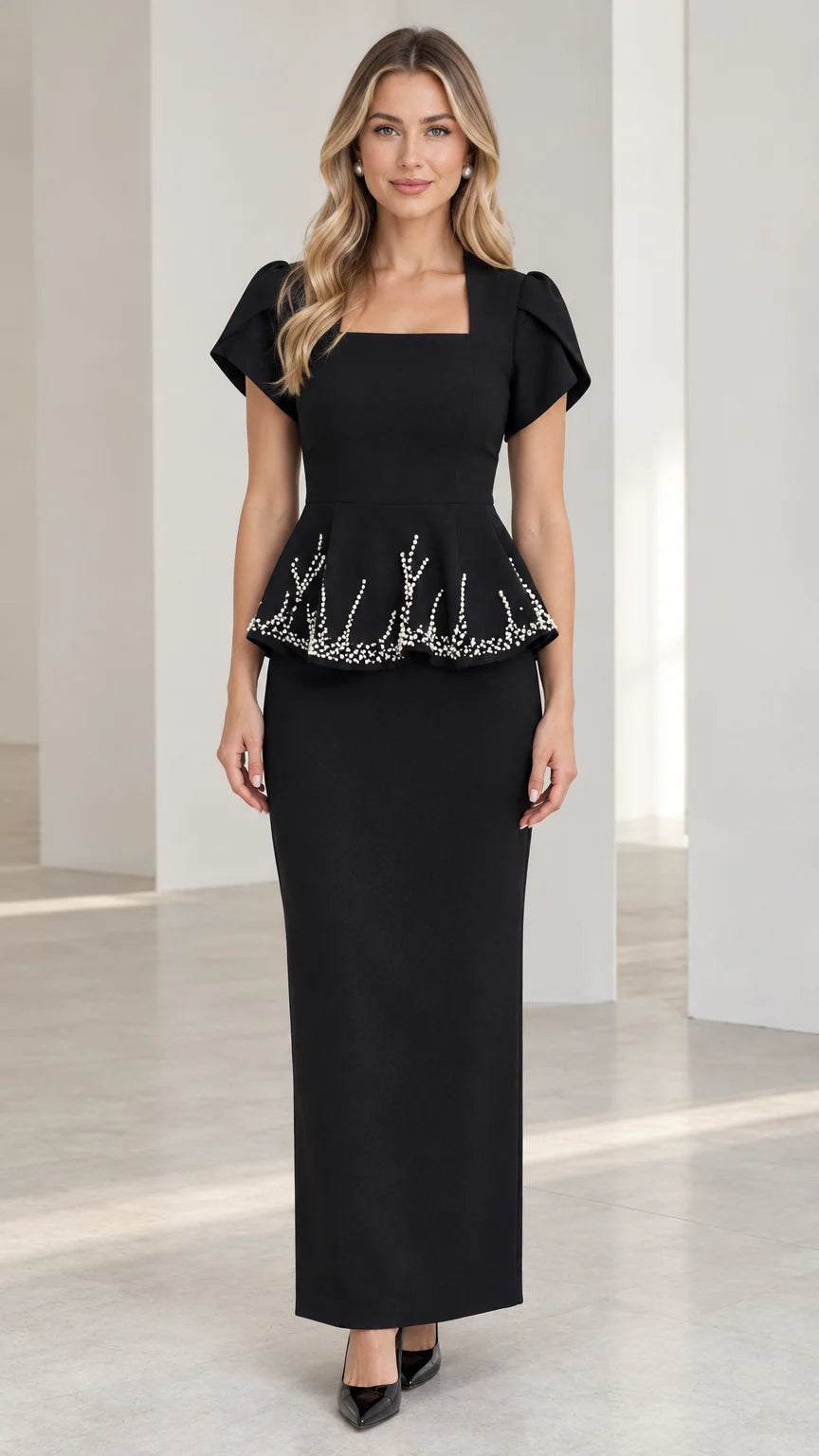 Front view of model wearing black square neck beaded peplum maxi dress