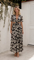 Front view of model wearing black floral cutout maxi dress