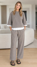 Front view of woman wearing taupe layered-look sweatshirt and wide-leg lounge pants set