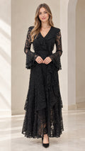 Front full view of woman wearing black tiered floral lace maxi dress with bell sleeves