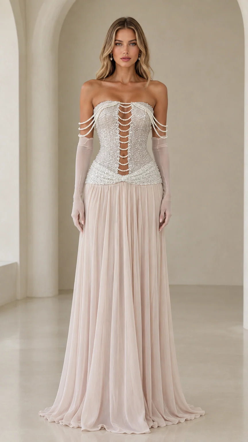Front view of model wearing champagne strapless pearl corset evening gown with sheer gloves