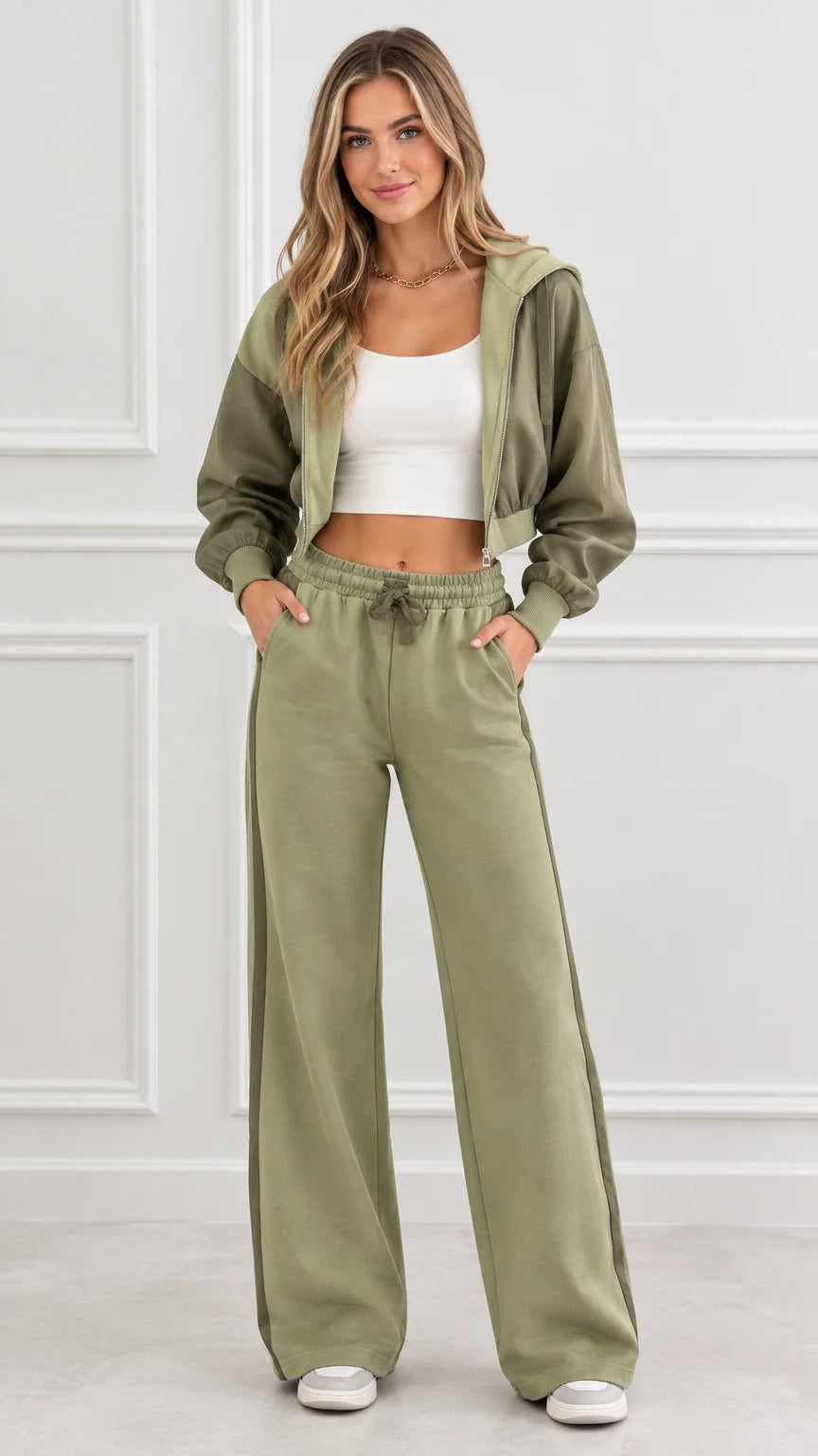Front full view of woman wearing olive green cropped zip-up hoodie and wide-leg track pants set