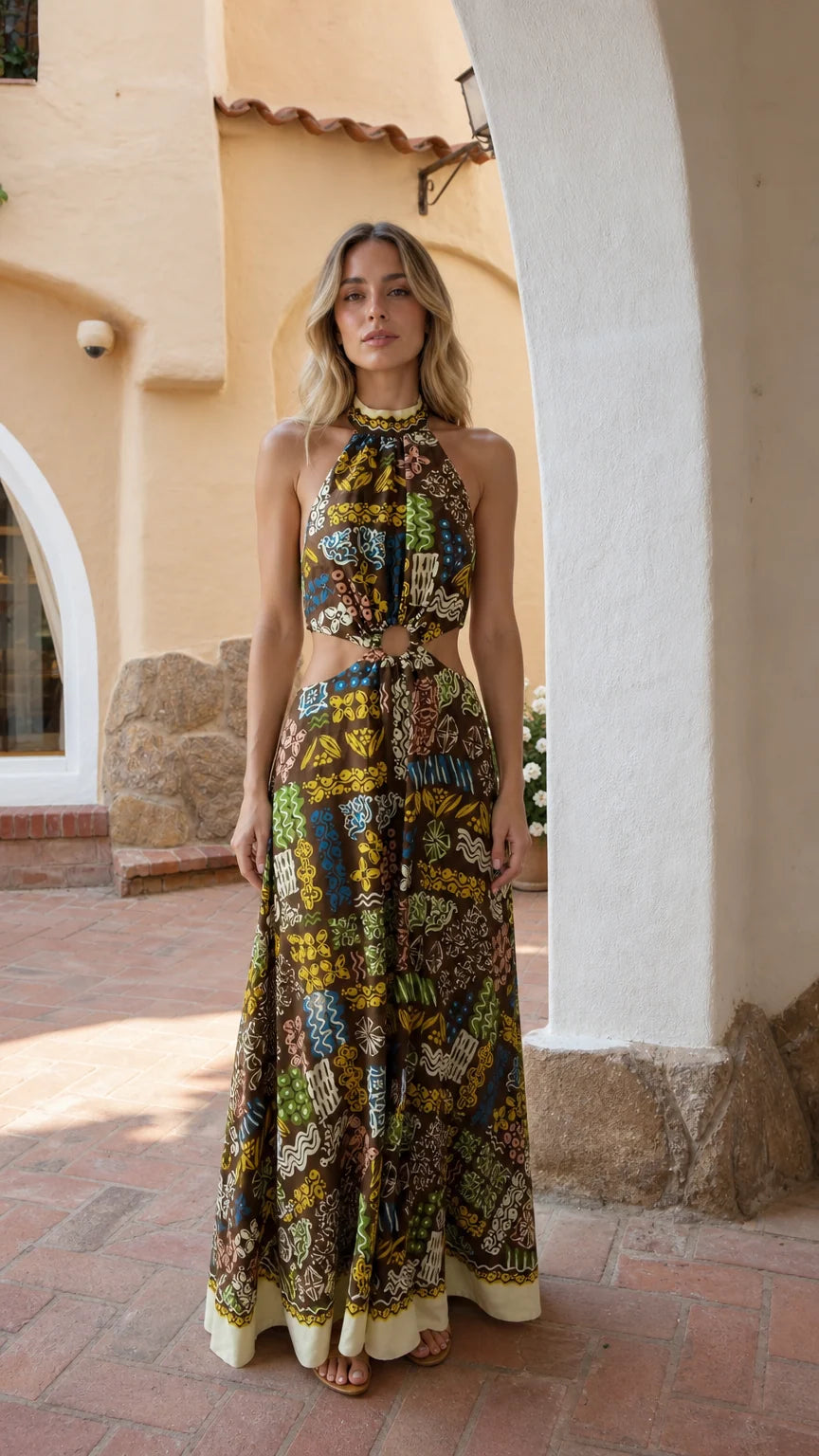 Full front view of model wearing brown printed halter neck cutout maxi dress