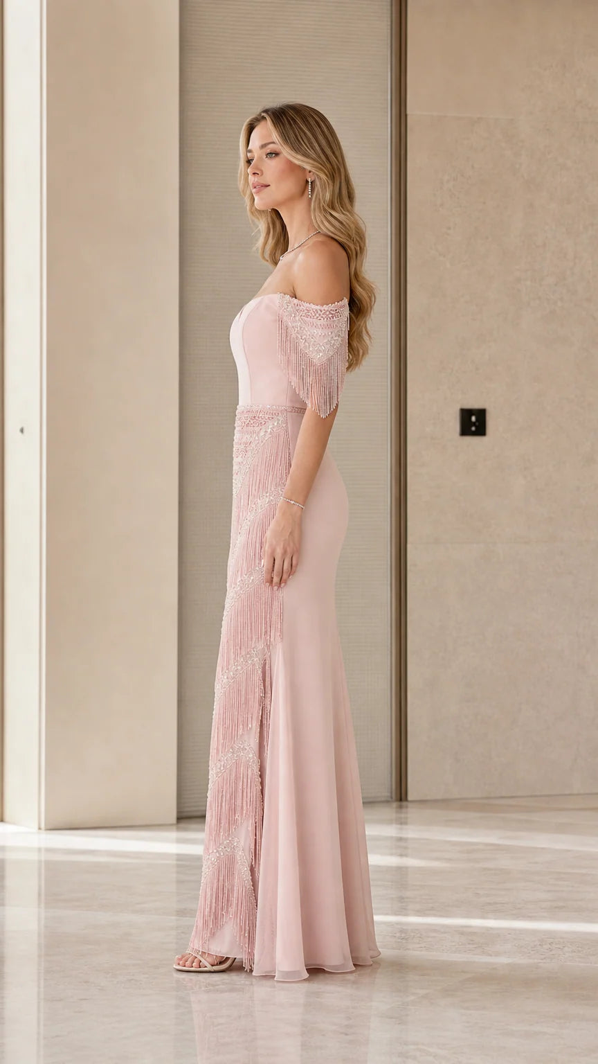 Side profile view of dusty rose evening dress highlighting fringe skirt and sleeve details