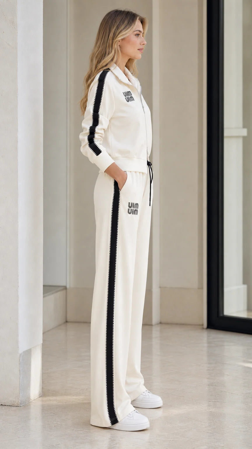 Side profile of model in Cream tracksuit showing contrast side stripe detailing