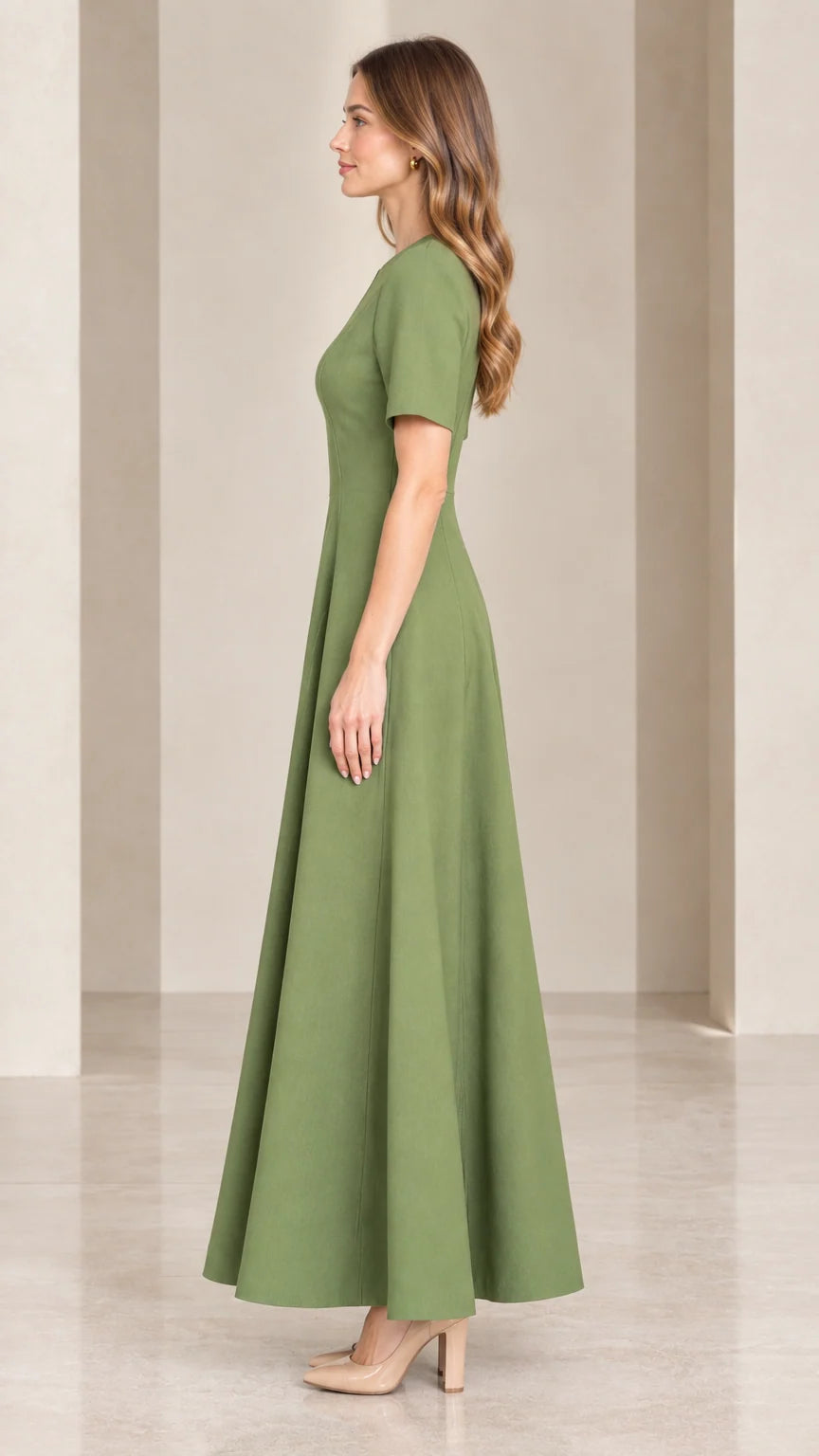 Side profile view of woman wearing sage green tailored maxi dress