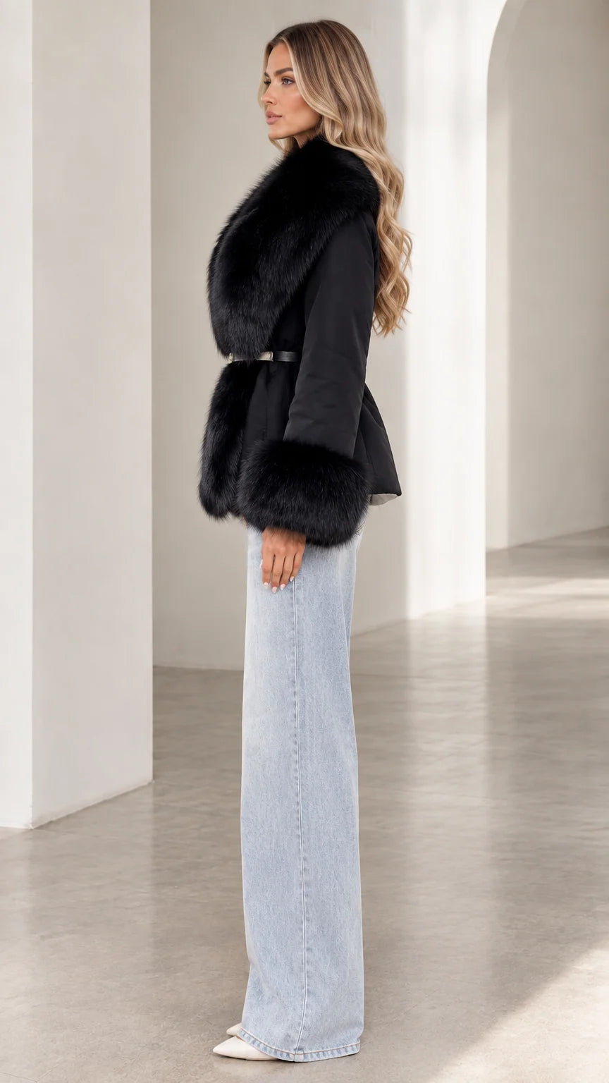Side profile view of model wearing black faux fur belted coat with wide-leg denim