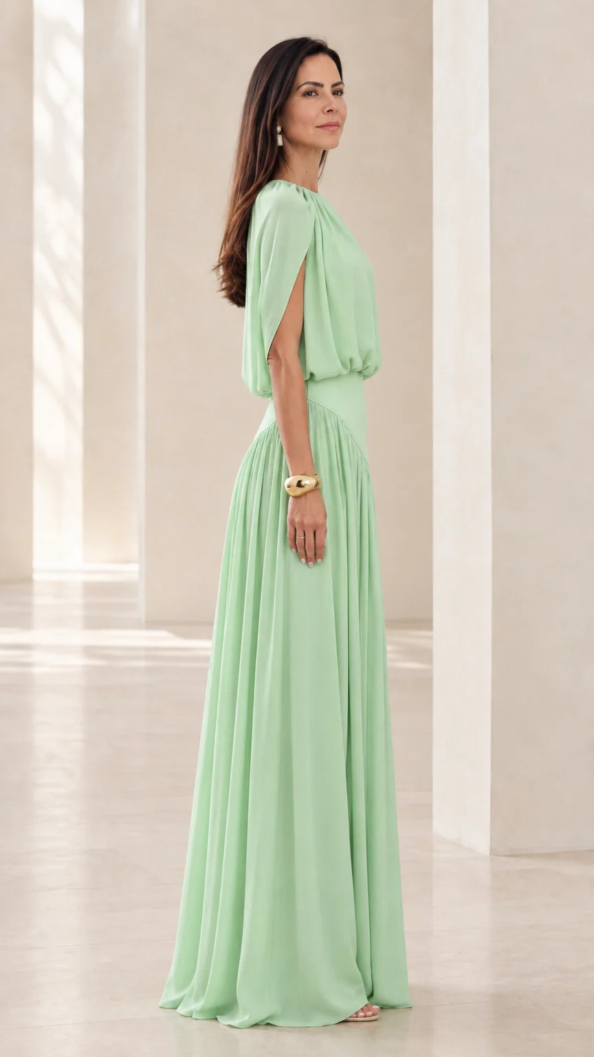 Side view of model wearing Mint Green maxi dress highlighting slit capelet sleeves