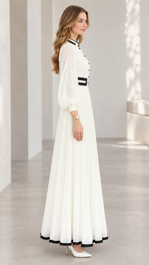 Side profile view of white long sleeve pleated A-line maxi dress