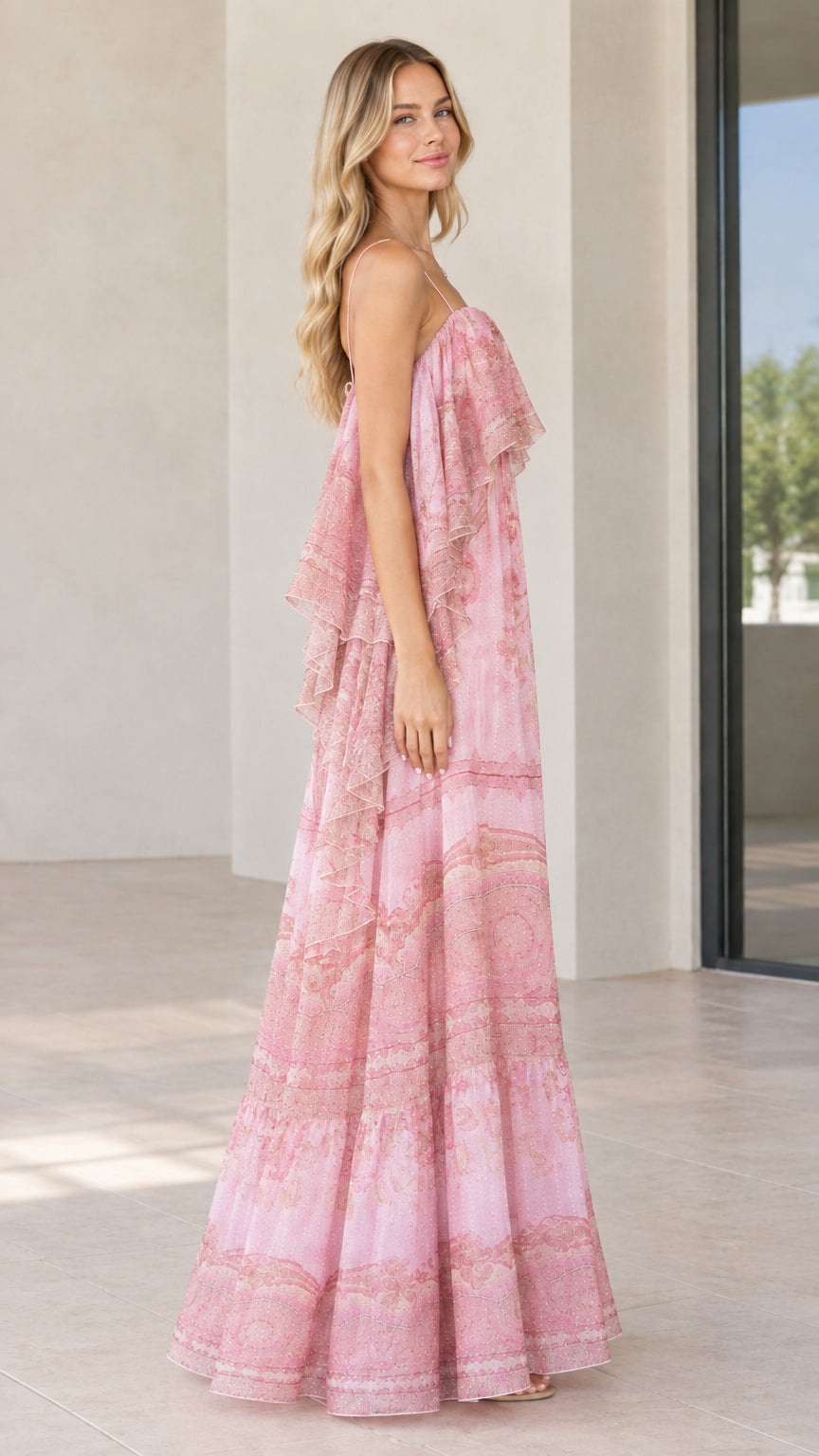 Side view of woman posing in pink ruffle flutter sleeve tiered maxi dress