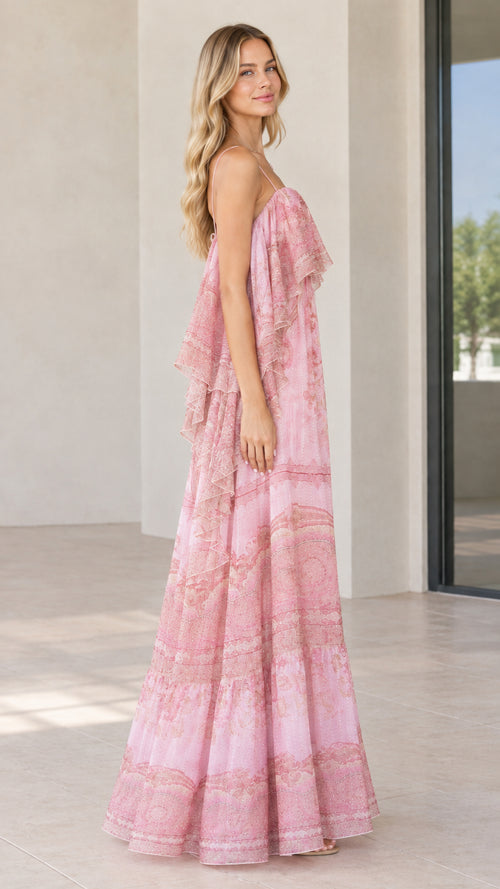 Side view of woman posing in pink ruffle flutter sleeve tiered maxi dress