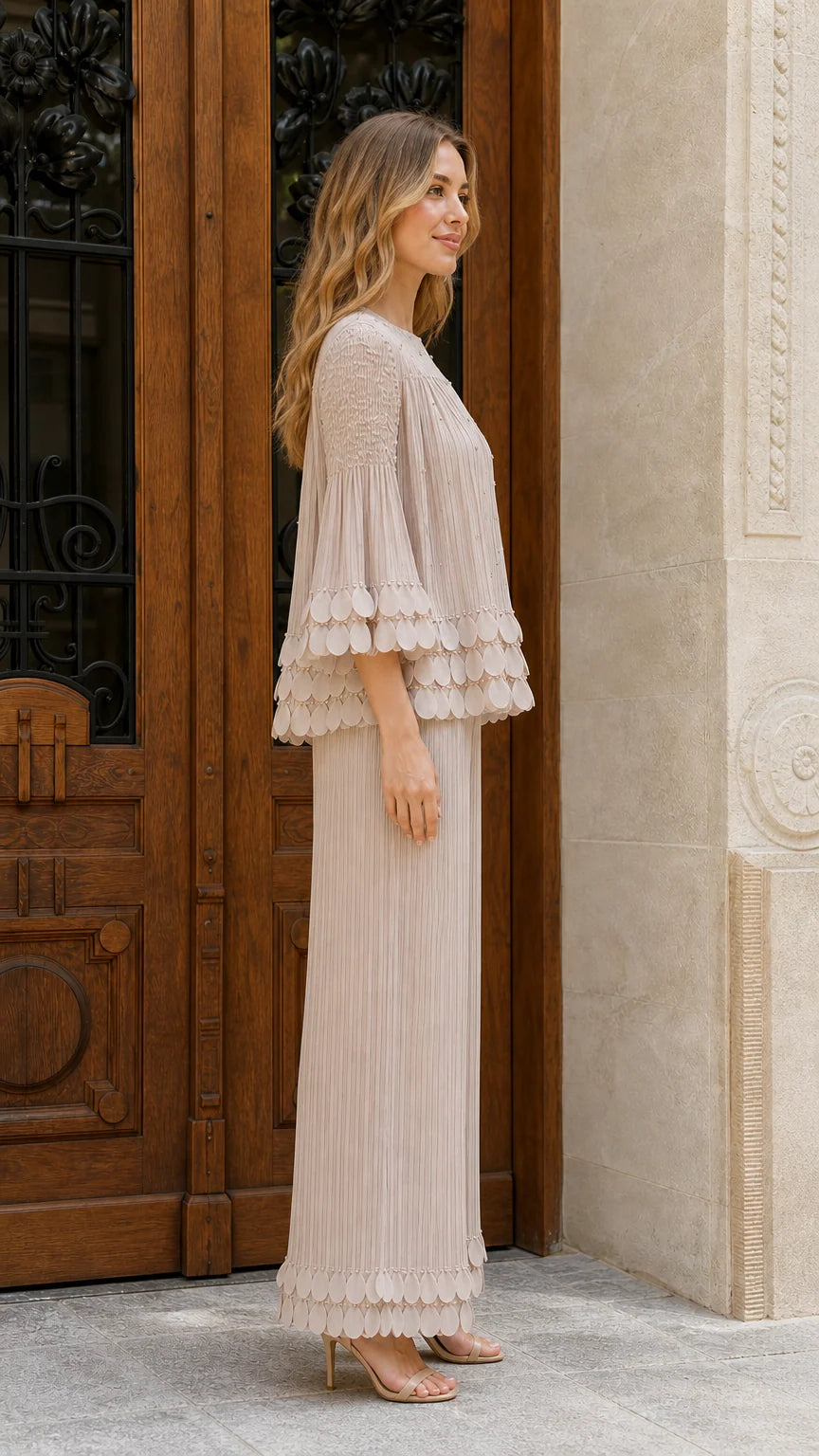 Model wearing beige pleated two-piece set side view