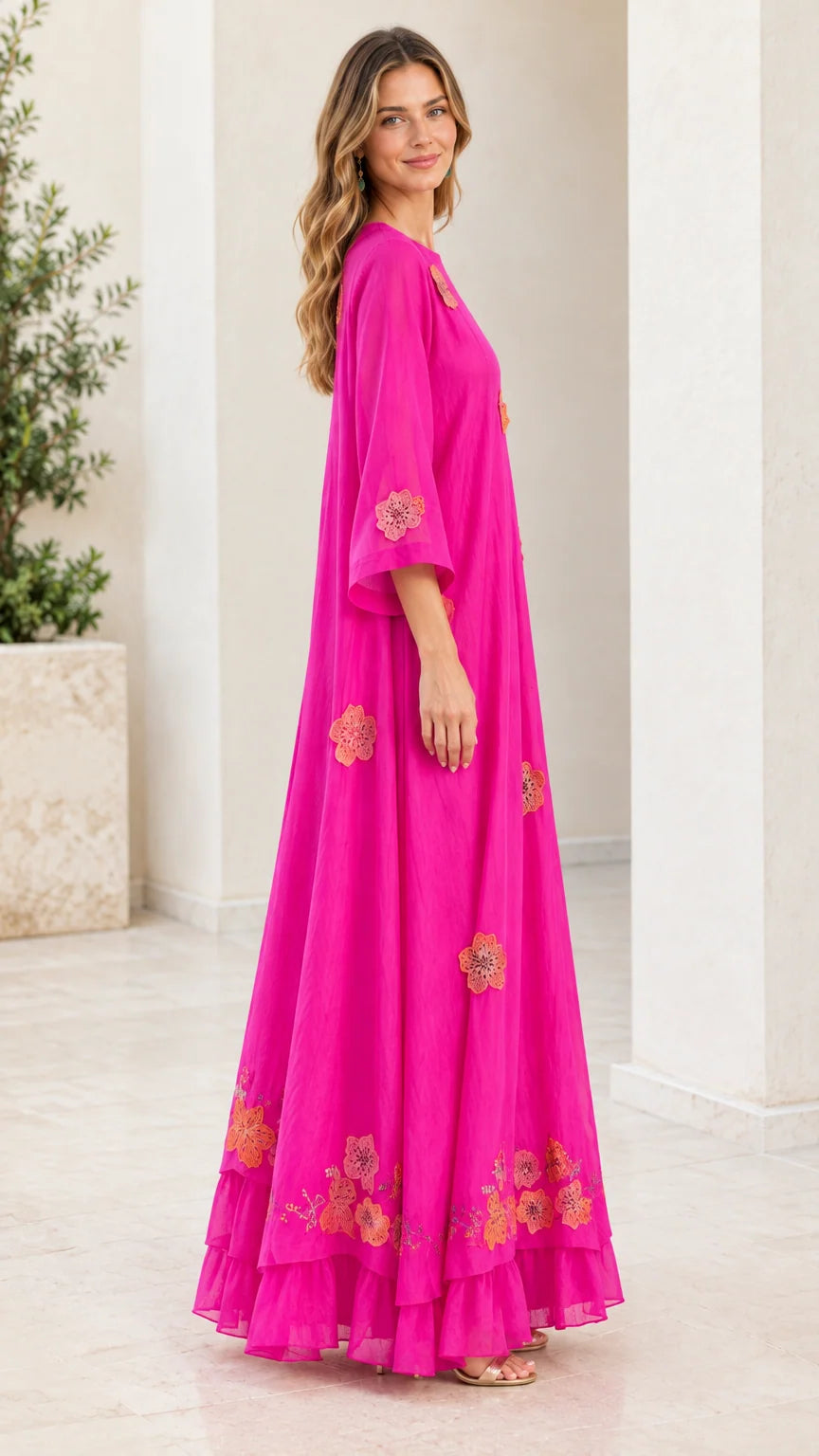 Side profile of fuchsia flowing maxi dress with 3/4 flared sleeves