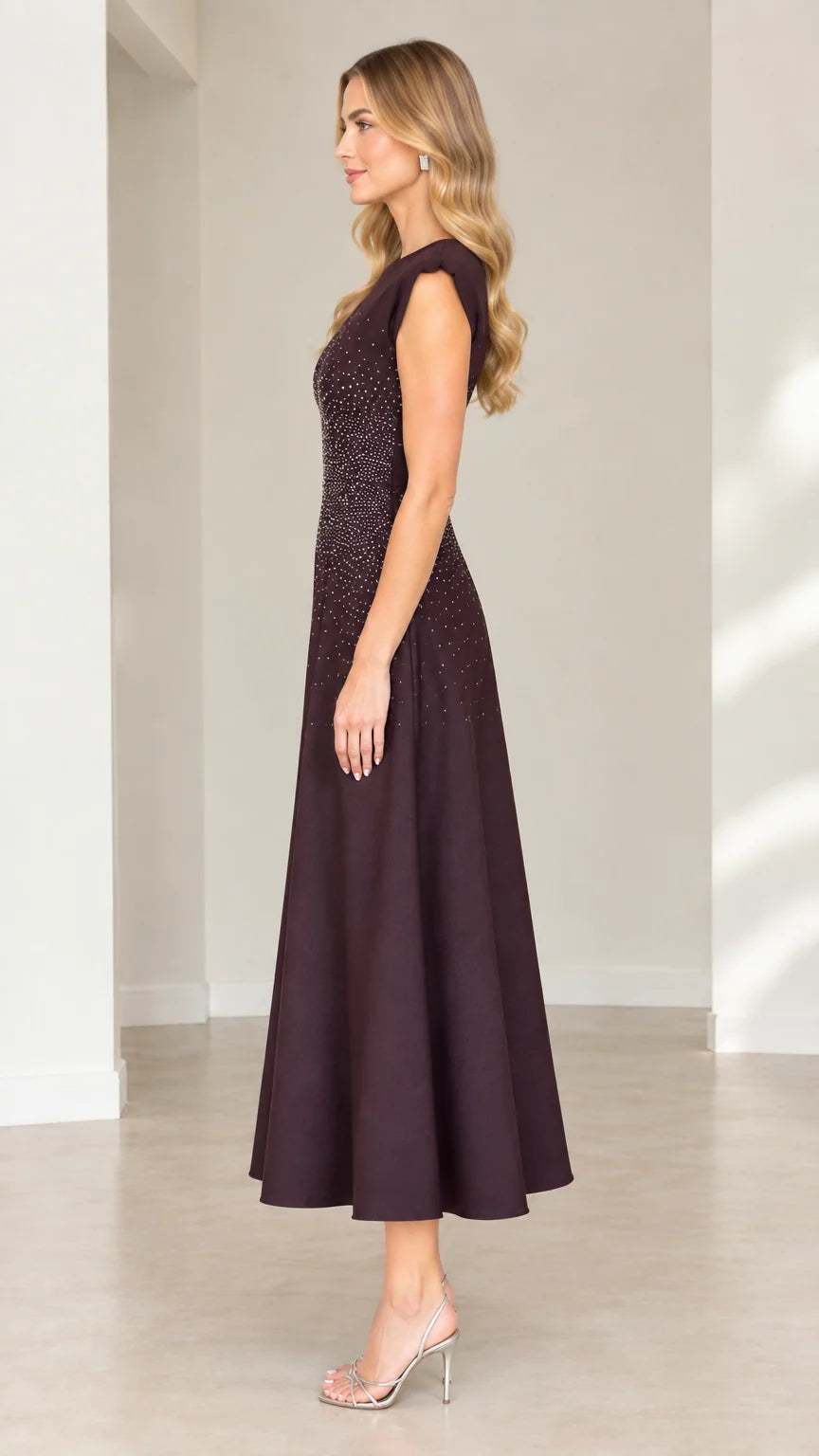 Side profile view of plum rhinestone embellished fit and flare midi dress