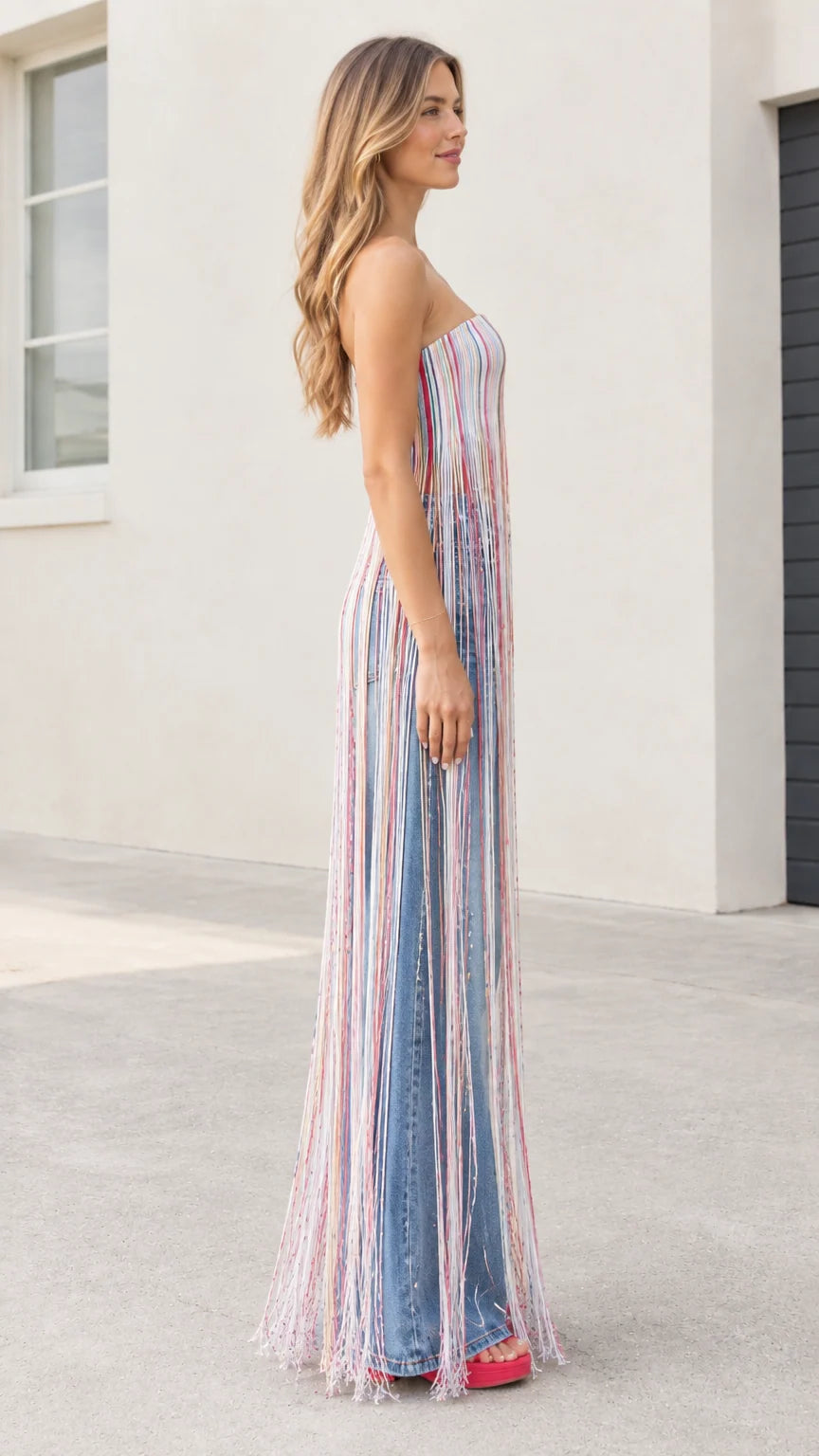 Side profile of model wearing strapless striped maxi fringe tube top showing full fringe length