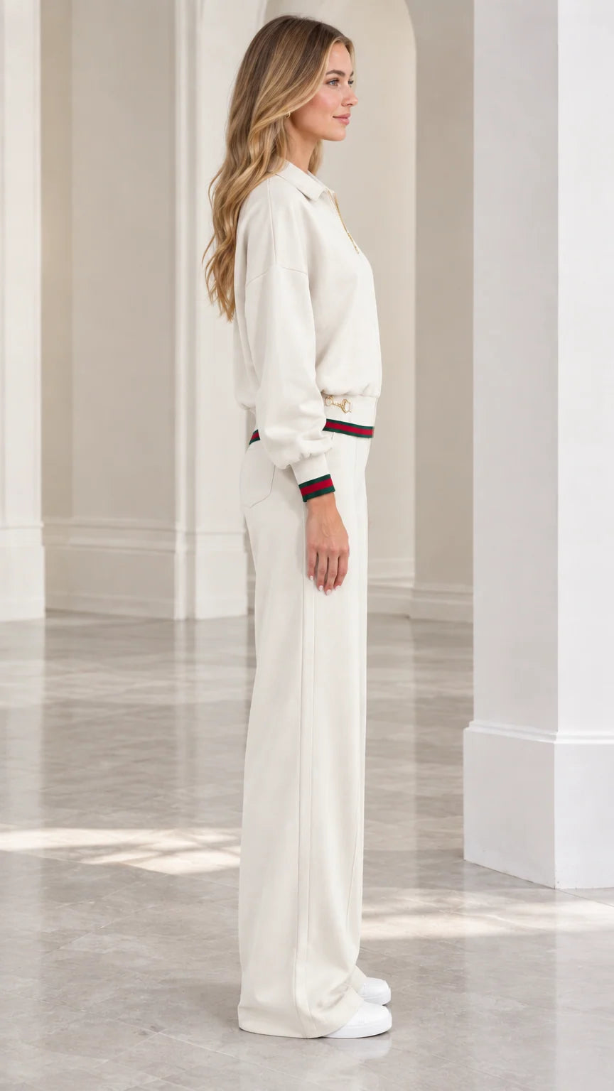 Side profile view of women's cream two-piece tracksuit set
