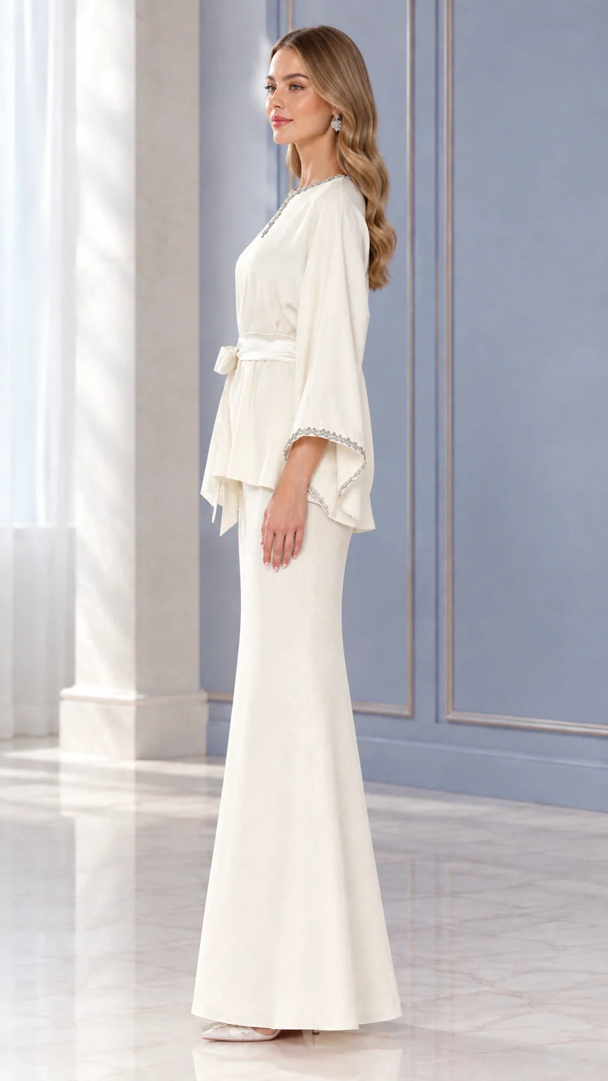 Side profile view of woman wearing Ivory two-piece embellished evening skirt set