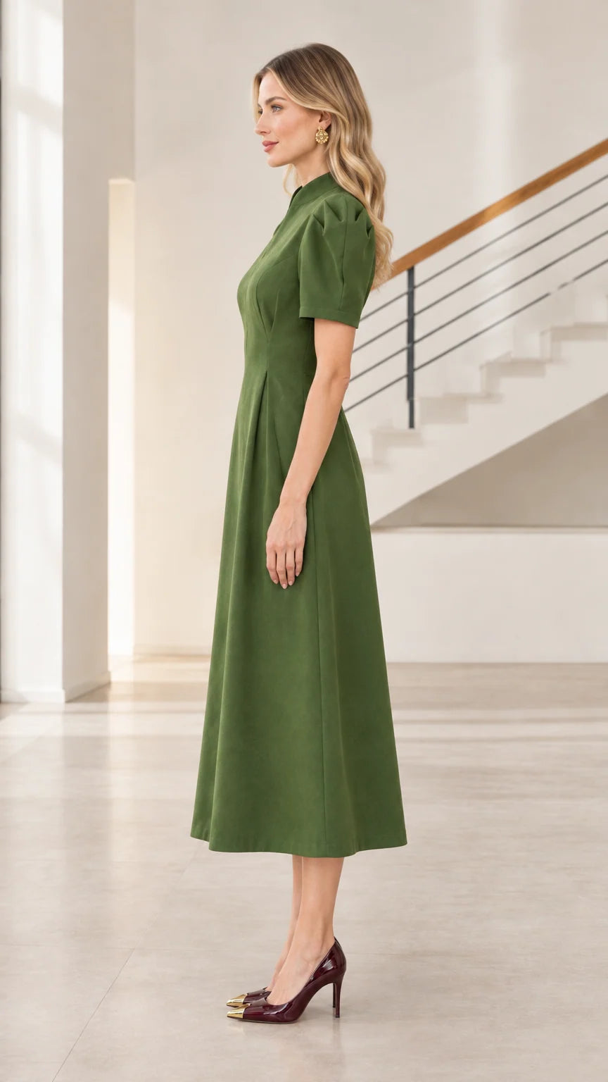 Side profile of model wearing olive green puff sleeve pleated waist midi dress
