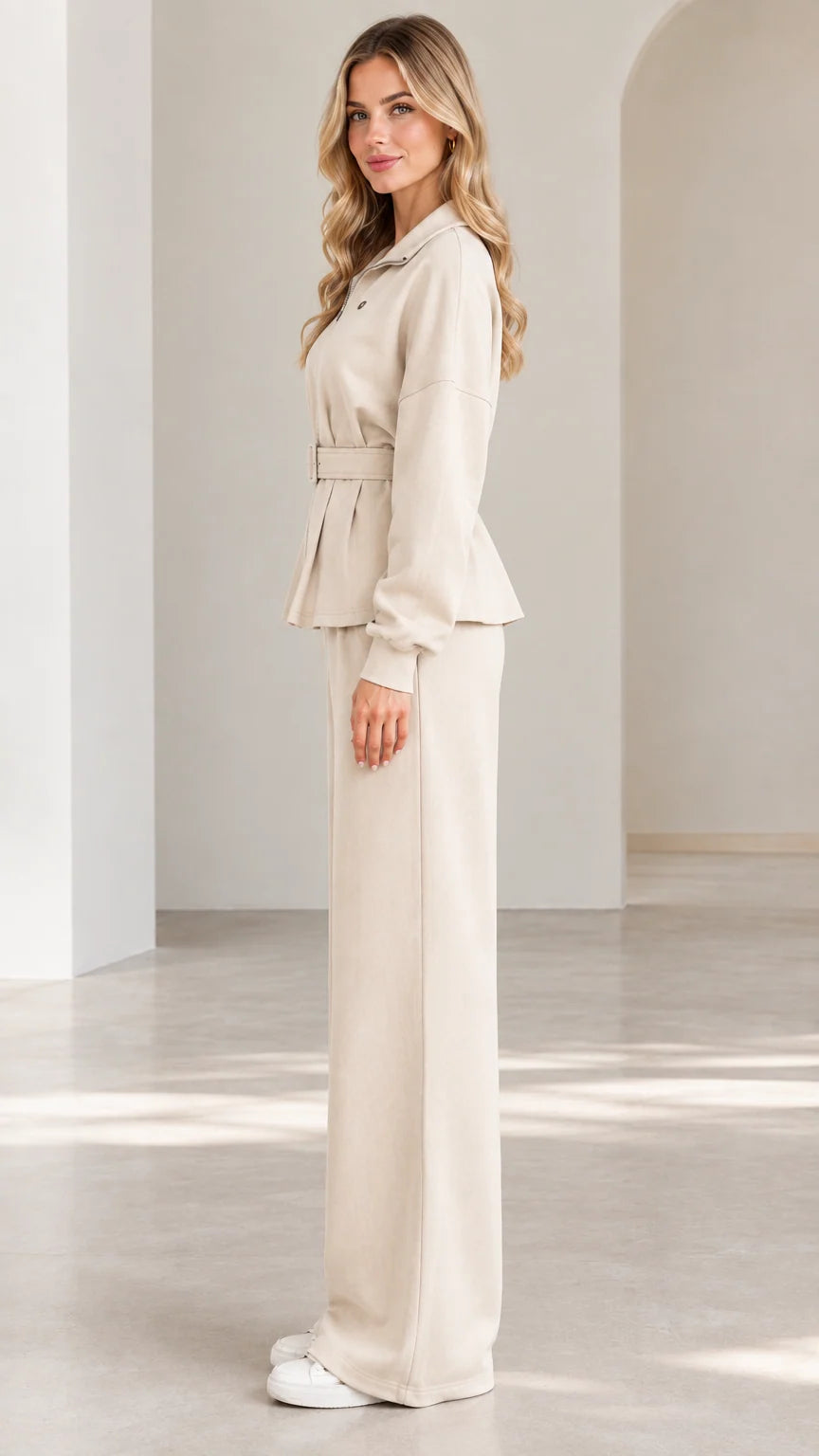 Side full-length view of woman wearing beige belted two-piece matching set