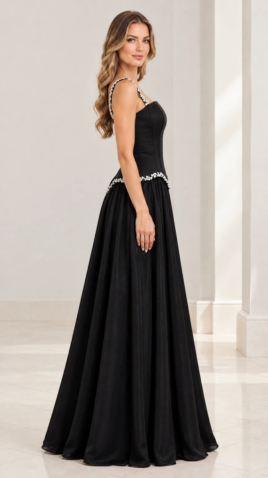 Side profile view of the floor-length black evening dress with crystal straps